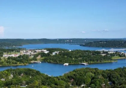 Aerial view of a lake surrounded by trees and buildings