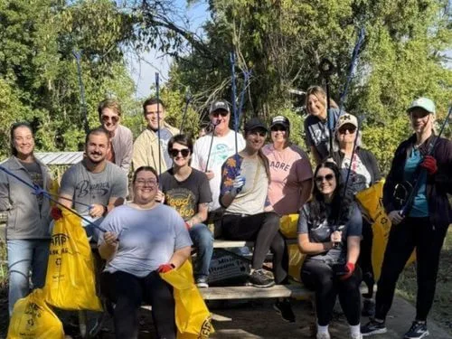 A group of people cleaning up the park, promoting environmental responsibility and community engagement.