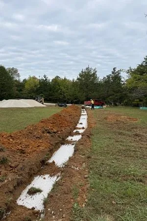 A trench in a field with a cloudy sky